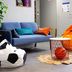 ibis budget Lunel Porte de Camargue lounge with blue sofa, bean bags and basketball decor in Aimargues