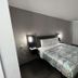 Motel 6-Altoona, IA - Des Moines East guest room with queen bed and window with dark curtains