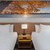 Days Inn by Wyndham Mason City guest room with two beds and a scenic sunset wall art