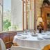 Logis Hotel Bergeret Sport in Hendaye dining room with set round table beside open window