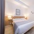 Hotel Victori in Es Castell guest room with double bed, bedside lamps and air conditioning