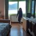 Al Poggio in Omegna guest room with lake view through a large window and a bed in the foreground