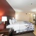 Red Roof Inn Raleigh Southwest - Cary room with king bed, TV, and wood flooring in Cary