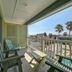 Seashell Village Resort Port Aransas balcony with chairs and view of palm trees and pool