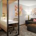 SpringHill Suites by Marriott Beaufort guest suite with sofa, desk, and partitioned bed area in Beaufort