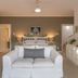The Knysna Belle Guest House in Knysna: bright guest room with white sofa, bed and dresser