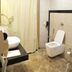 Hotel Tridev, Varanasi: modern bathroom with toilet, sink, shower curtain and marble-style flooring