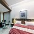 The Unicontinental - Campus Accommodation in Mumbai room with glass dining table and bed