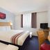 Ramada by Wyndham Wakefield room in Ossett with double bed, TV, desk and window with curtains