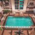 Starlodge Jerudong courtyard pool with string lights and surrounding balconies
