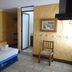 Hotel Casa Vieja Puerto Escondido room with bed, chair, tiled floor and framed wall art