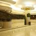Oasis Tower Shanghai hotel lobby with marble reception desks and polished floor