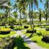 Hotel Cocomar Beachfront Hotel in Parrita with palm-lined tropical gardens and winding paths