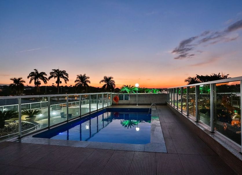 San Diego Suites Pampulha Hotel rooftop pool at sunset in Belo Horizonte