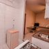 Pampulha Flat Belo Horizonte kitchen and laundry area with sink, cabinet and small table