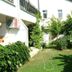 Gultepe Apartments in Kusadasi with a green garden courtyard and white exterior buildings