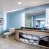 Hotel Indigo Jacksonville-Deerwood Park bathroom with glass shower, double vanity, toilet and tiled floor