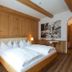 Hotel Englhof, Zell am Ziller: cozy wooden guest room with double bed and alpine-style decor