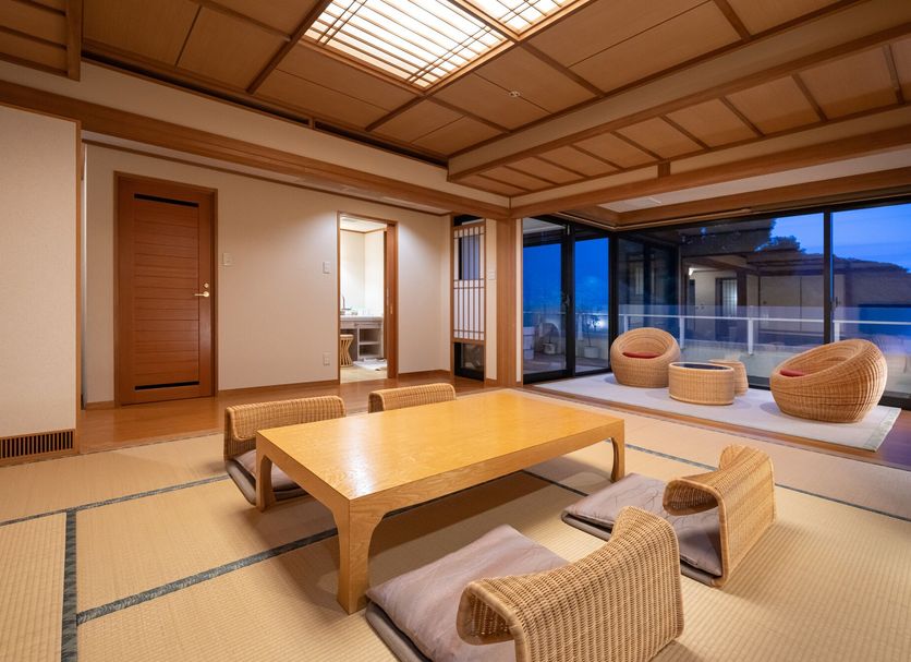 Kirishima Kokusai Hotel in Kirishima, tatami room with low table and floor cushions beside large windows