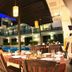 Chalay Monta Hua Hin courtyard dining by the pool at dusk with modern hotel building