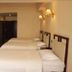 Chengdu Tianfu Lidu Hotel in Chengdu with triple beds in a simple guest room