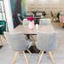Forest Village Resort in Medjugorje dining area with light wood tables and gray upholstered chairs