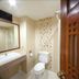 Baan Klang Hua Hin bathroom with sink, toilet, mirror, and patterned accent wall in Hua Hin