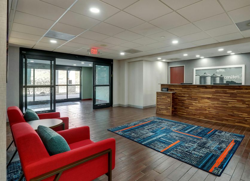 Hampton Inn & Suites St. Louis-Edwardsville lobby with front desk, red chairs, and entrance in Glen Carbon