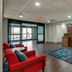 Hampton Inn & Suites St. Louis-Edwardsville lobby with front desk, red chairs, and entrance in Glen Carbon