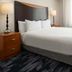 Fairfield Inn & Suites by Marriott Santa Maria guest room with king bed and bedside lamps