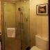 Gold River Side Hotel Jiaxing bathroom with glass shower, sink vanity and toilet
