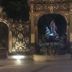 Hotel Les Portes D'Or in Nancy, ornate illuminated gate with central statue at night