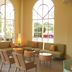 La Quinta Inn & Suites by Wyndham Sarasota Downtown lobby seating area with arched windows and lounge chairs