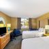 La Quinta Inn & Suites by Wyndham Sarasota Downtown guest room with two beds and a window view
