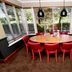 Premier Inn Isle Of Wight - Newport dining nook with round table, red chairs, and large windows