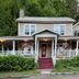 Whiteface Farm Adirondack Bed and Breakfast in Wilmington, front porch and red steps amid greenery