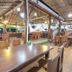 OYO 75353 Loy Chalet Resort dining area in Nakhon Si Thammarat with wooden tables and open-air seating