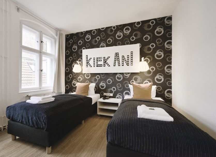 Old Town Hotel Berlin twin guest room with two single beds and patterned accent wall