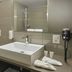 Aparthotel Baden bathroom with sink, toilet, shower, and wall-mounted hair dryer