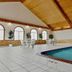 Home Suites in Thief River Falls indoor pool with arched windows and seating area