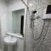 Rimtarn Hotel Pakchong bathroom with sink, mirror, toilet, and wall-mounted shower in Pak Chong