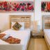 Gili Amor Boutique Resort in Pemenang twin bed guest room with colorful wall art
