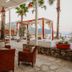 Ekincik Beach Hotel lounge terrace with palm trees and sea view in Ekincik