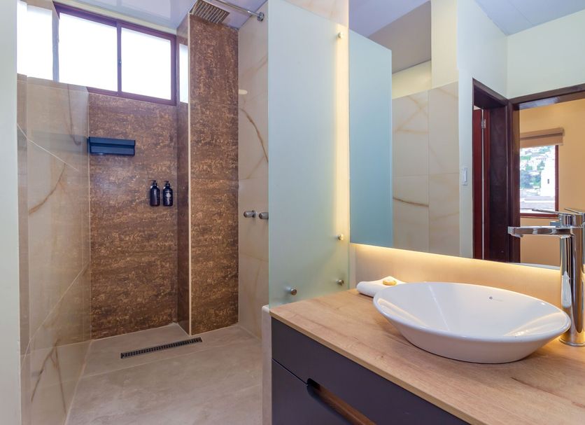 Friends Hotel & Rooftop Quito bathroom with walk-in shower and vessel sink