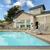 Hilton Garden Inn Roseville outdoor pool with lounge chairs and a hotel building in Roseville