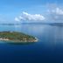 Iris Island Eco Resort in Busuanga with aerial view of a lush island surrounded by clear blue water