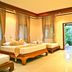 Oriental Siam Resort Chiang Mai bedroom with twin beds and garden view through open doorway