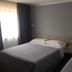 Piccolo, Lamezia Terme: twin beds in a simple hotel guest room with gray walls and window curtains
