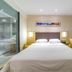 City Comfort Inn Foshan Zumiao Zhangcha guest room with king bed, glass-walled bathroom, and seating area