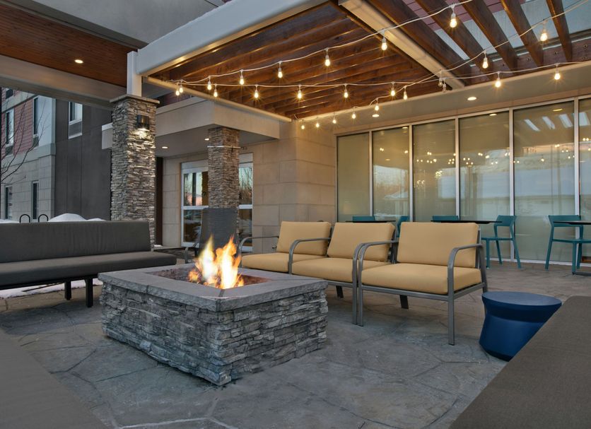Home2 Suites by Hilton Anchorage/Midtown outdoor fire pit lounge with seating and string lights